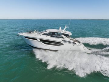 BRADventures at Full Throttle Drone side view of BRADventures, a 42’ Cruisers Yachts Cantius, cruising at high speed through the Gulf of Mexico with a clear blue wake trailing behind.