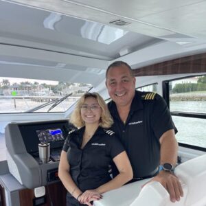 LivBlue Captain and Crew Aboard BRADventures in Naples, Florida Smiling captain and female crew member aboard LivBlue’s luxury charter boat in Naples, Florida, ready to guide your custom boat tour or yacht charter.