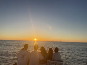 Group enjoying a sunset cruise on BRADventures yacht in Naples, Florida