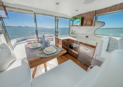 Modern galley aboard BRADventures yacht with dining table set for two