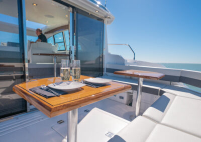Champagne setup in the cockpit seating area of BRADventures yacht cruising Naples, FL